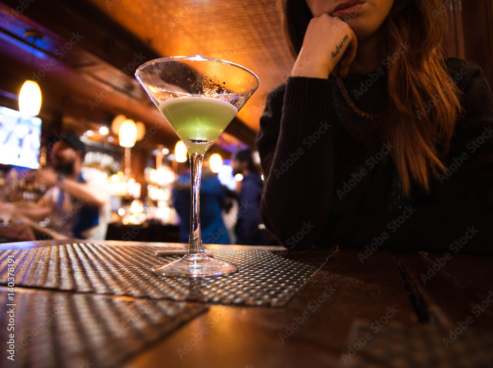 Woman having a conversation in a date at a cocktail bar.