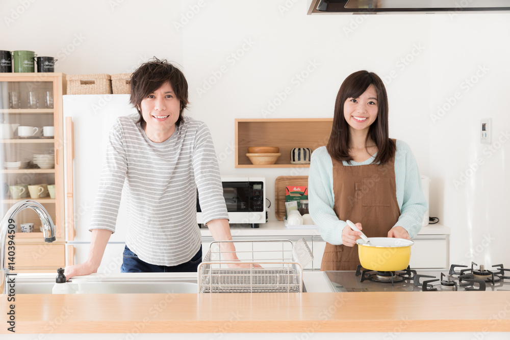 young asian couple cooking in kitchen