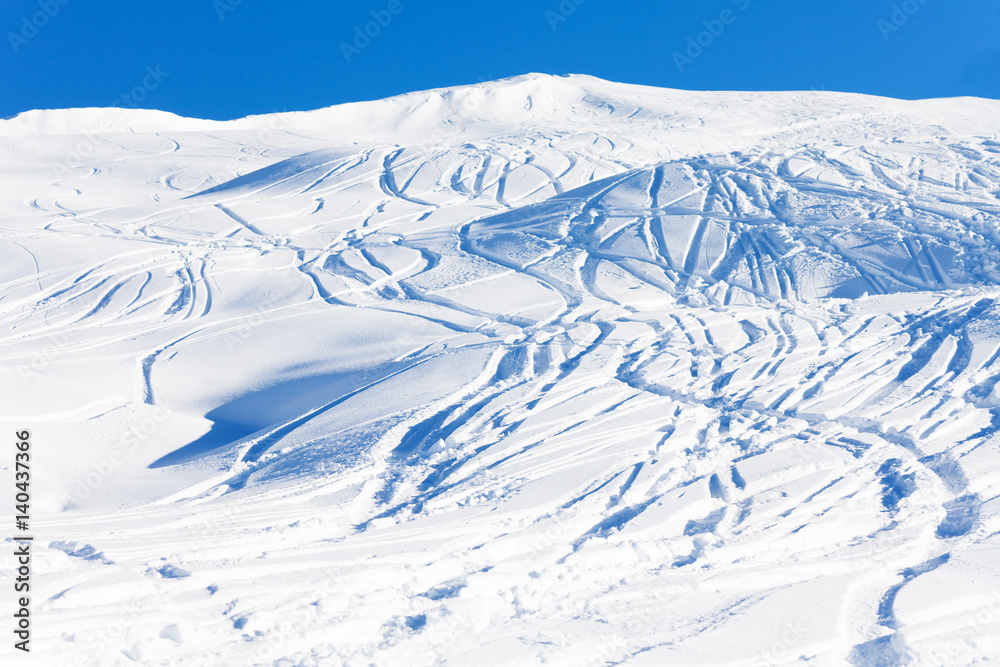 Traces of skis on snow-covered mountain slope