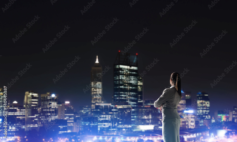 Woman looking at night city