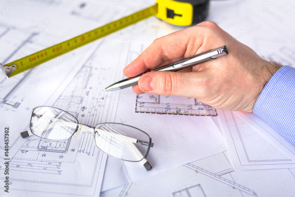 Construction plans on blueprints and measure