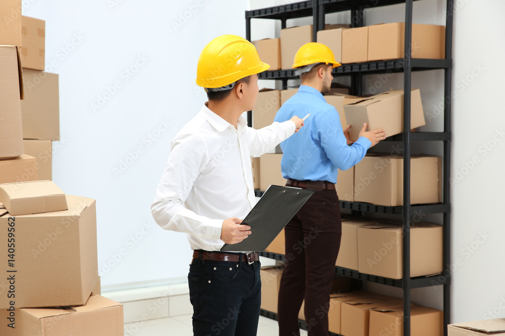 Managers checking orders at warehouse