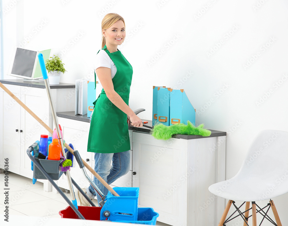 Woman cleaning table in office