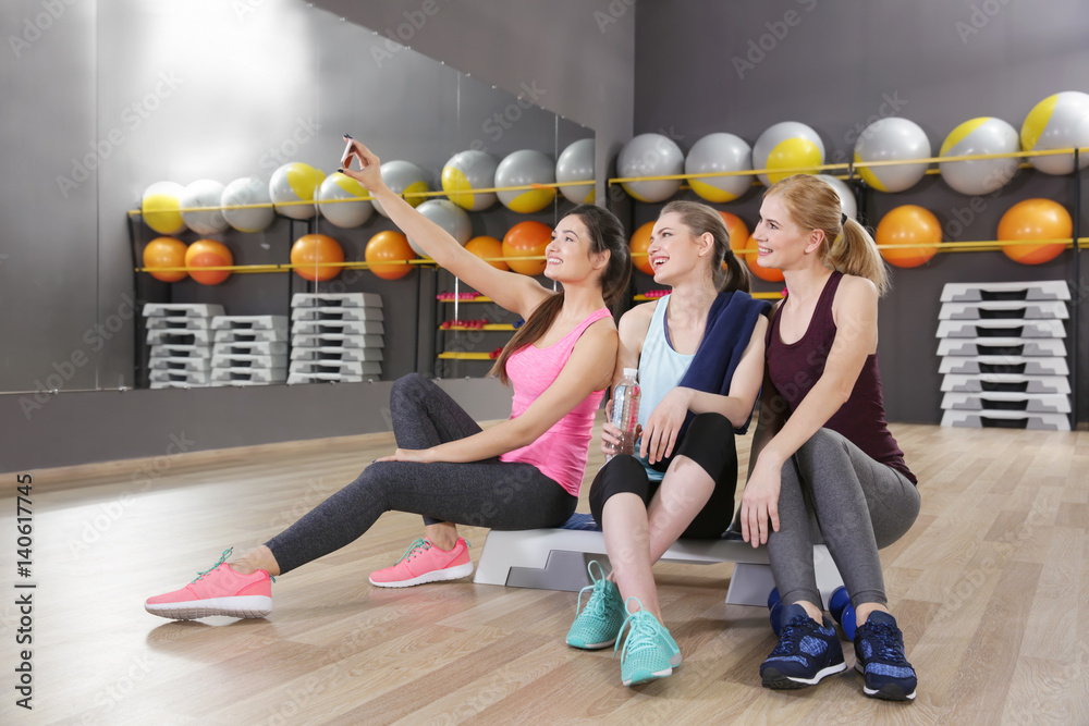 Young women taking selfie in gym