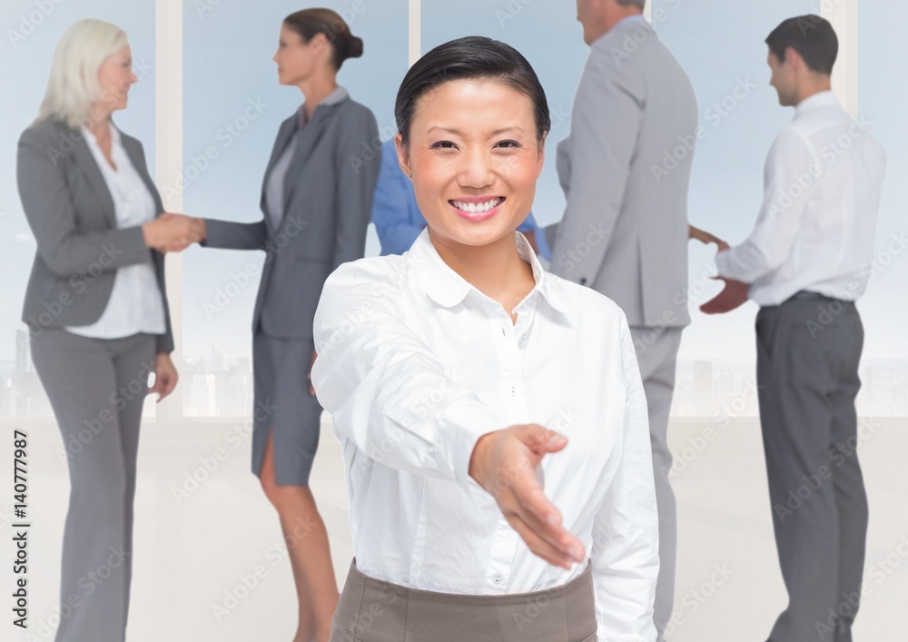 Handshake in front of business people at window