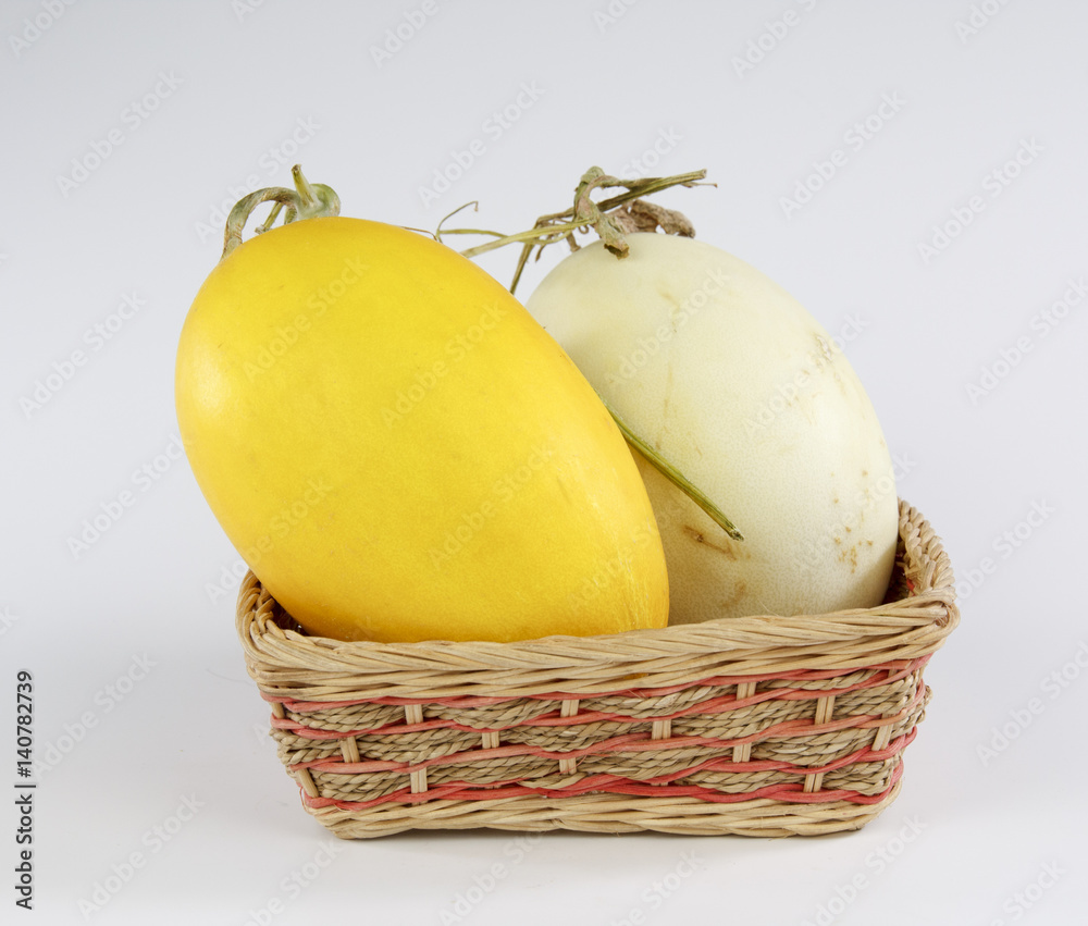 cantaloupe in a bamboo basket on white background
