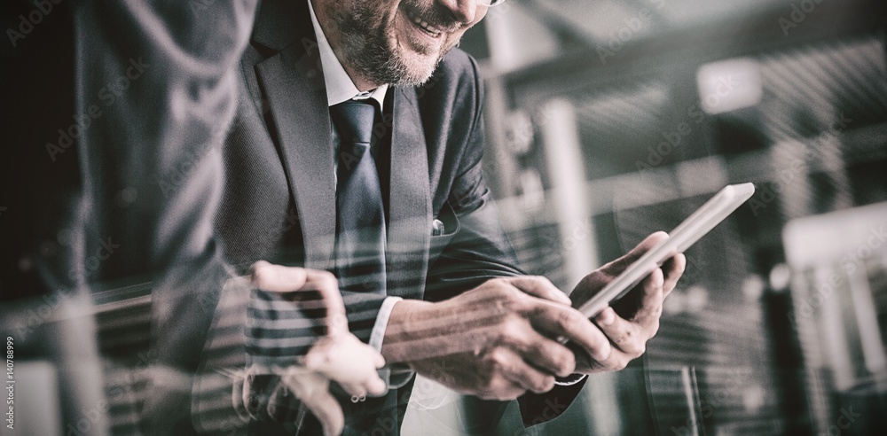 Businessman with colleague using digital tablet