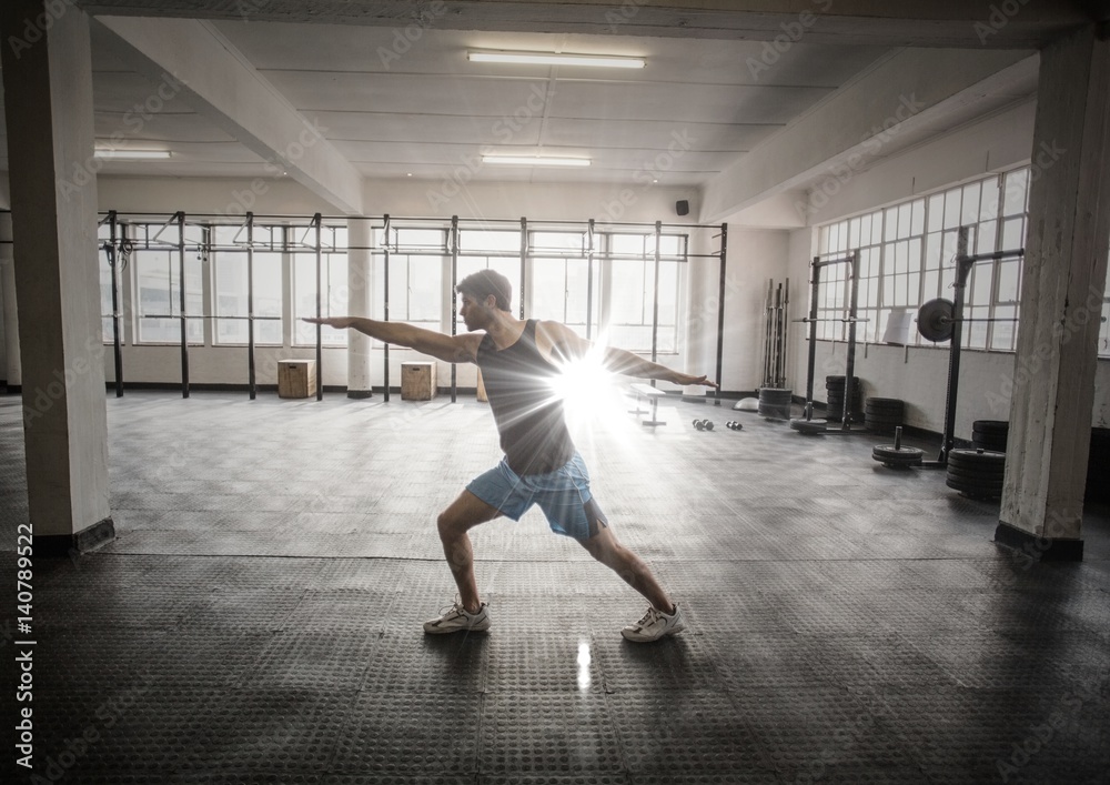 Man stretching in gym with flare