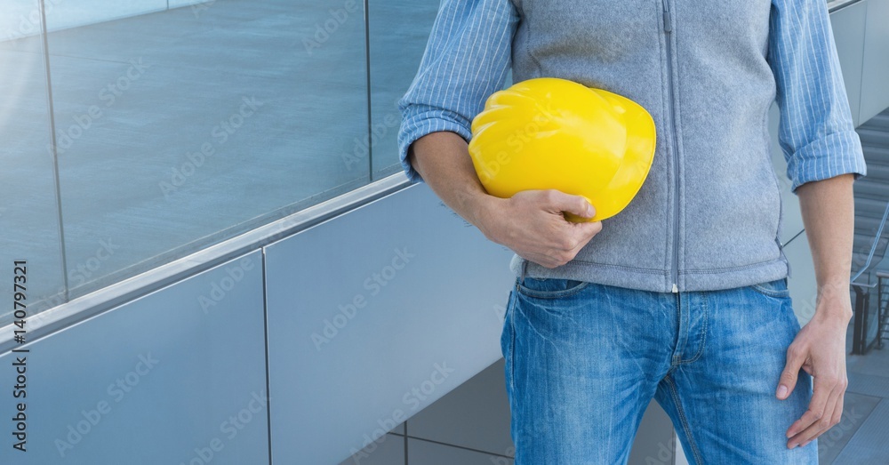 Architect Torso holding a cask against windows