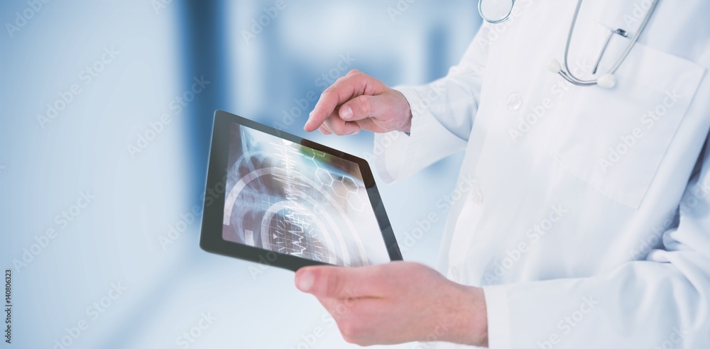 Composite image of doctor using digital tablet