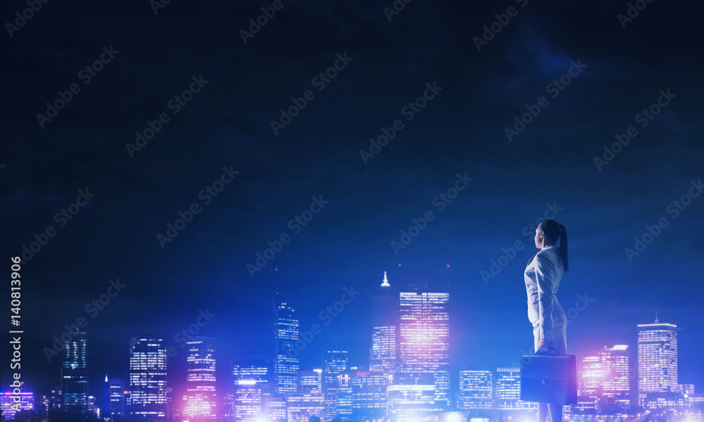 Woman looking at night city