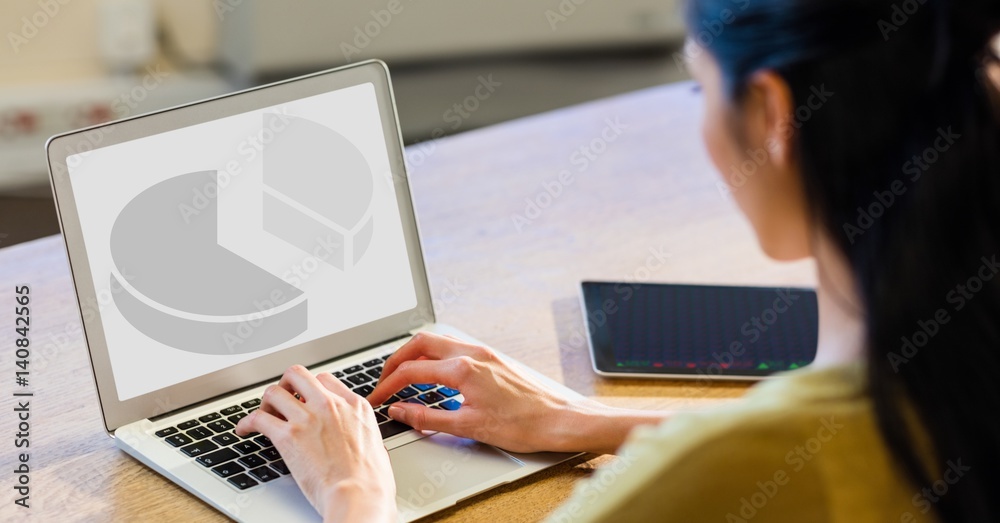 Woman working on laptop at desk