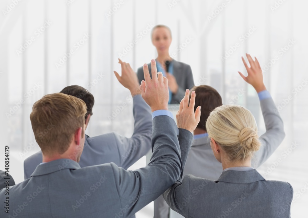 Businesspeople raising hands in meeting