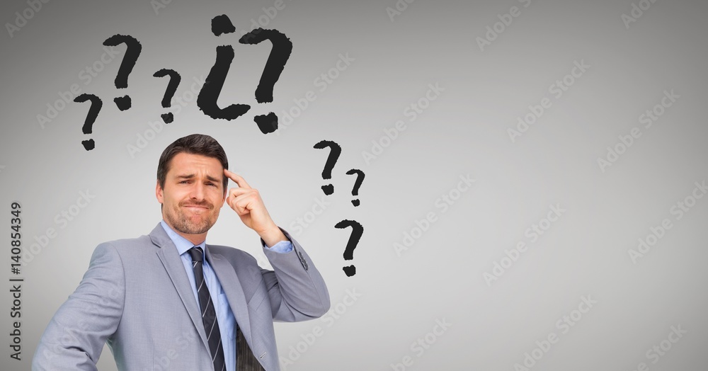 Businessman with question mark surrounding his head