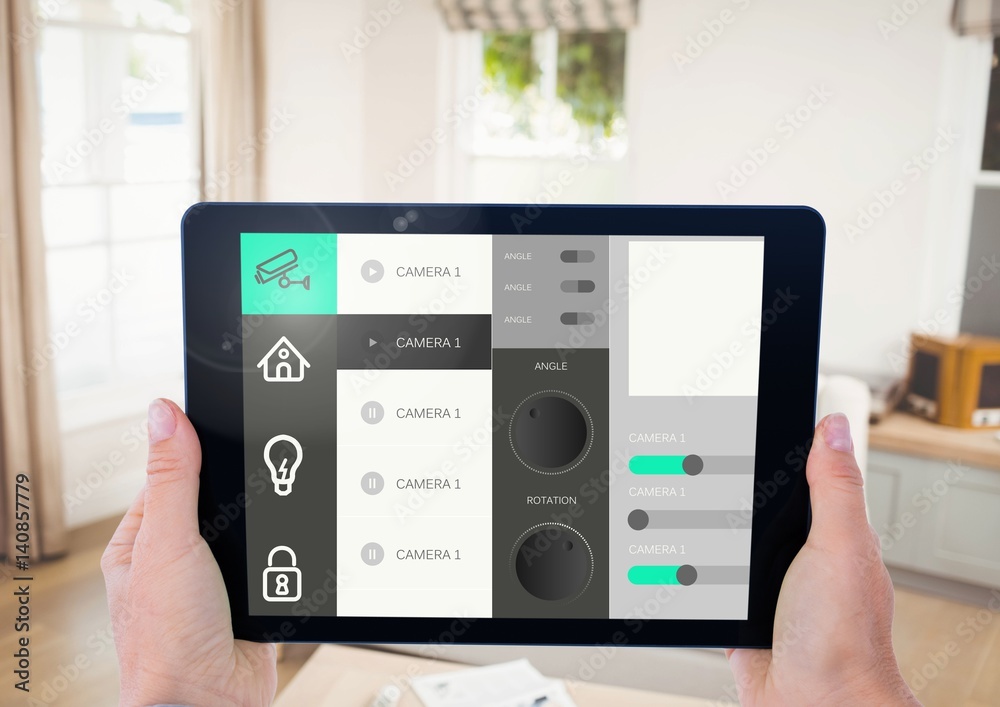 Hand holding digital tablet with home security icons on screen