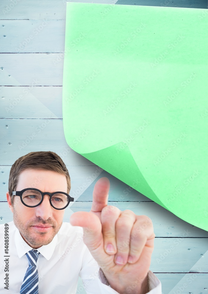 Businessman pointing at sticky note on wooden background