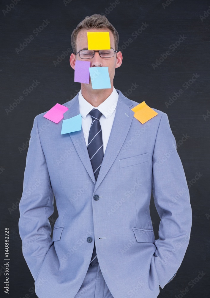 Businessman with sticky notes stuck on his face