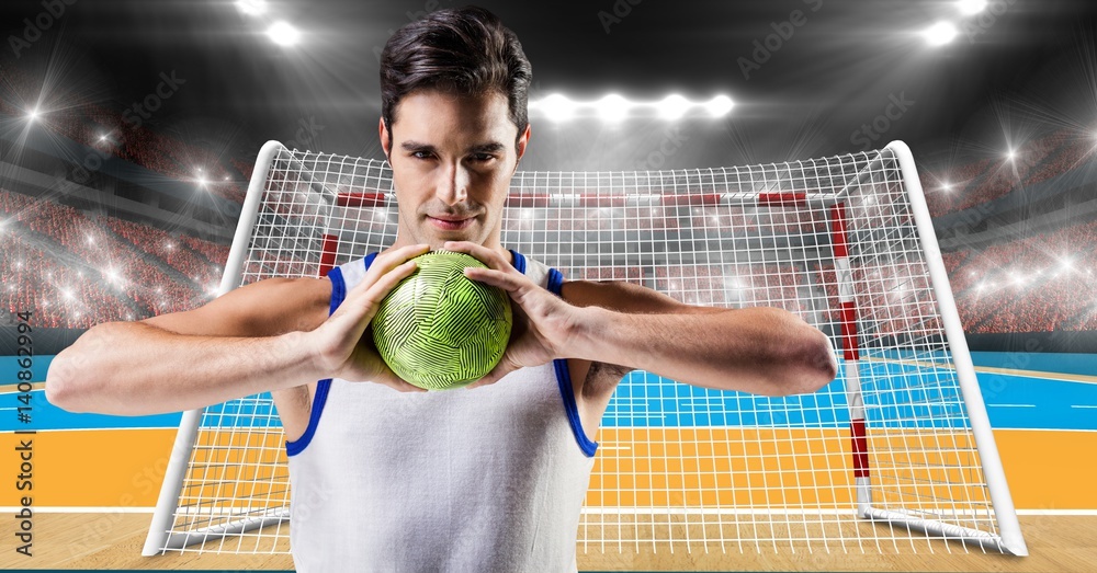 Athlete playing handball against stadium in background