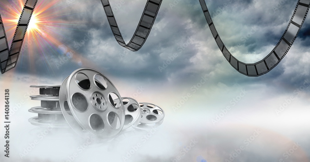 Film reels against sky in background