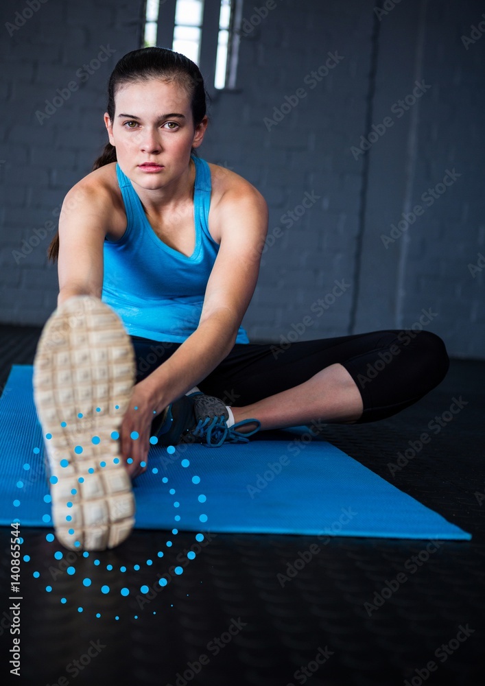 Portrait of woman exercising on mat