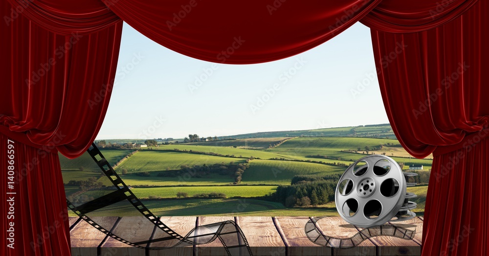 Film reel and curtain with scenic landscape in background