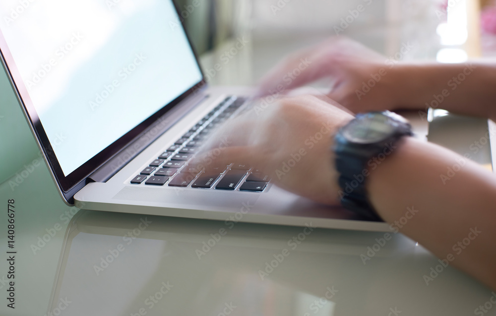 Hand typing on the laptop keyboard quickly ,motion blur effect.