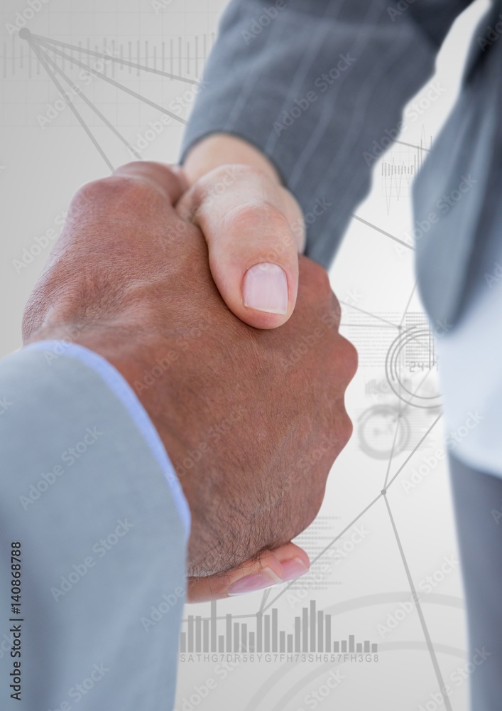 Business professionals shaking hands on technology background