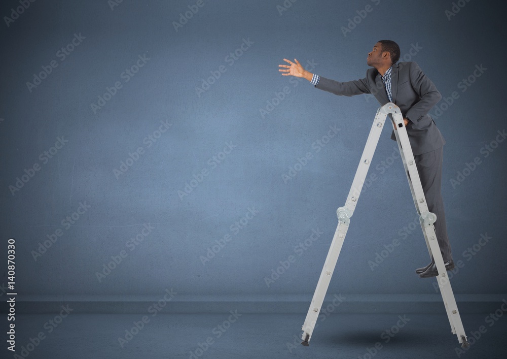 Businessman on ladder stretching his hand to reach