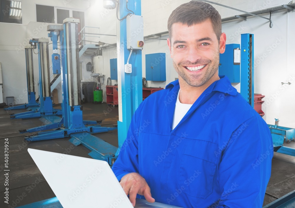 Mechanic using laptop at workshop