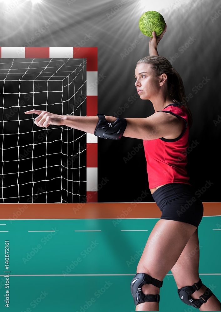 Focused player playing handball in stadium