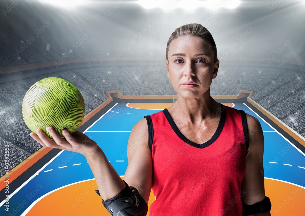 Determined player holding a handball in stadium