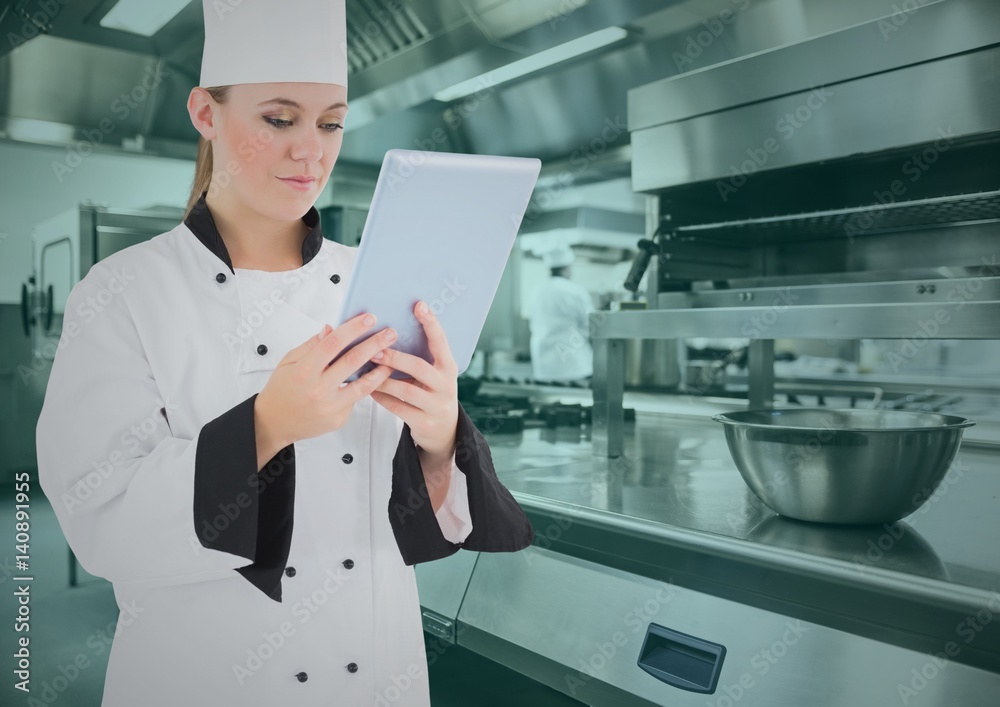 Chef using digital tablet in commercial kitchen