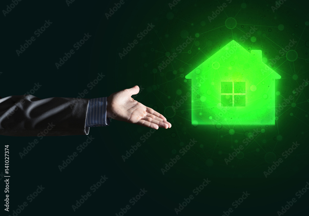 Conceptual image with hand pointing at house or main page icon on dark background