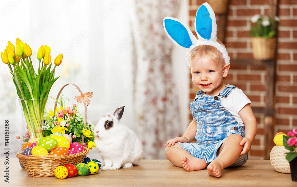 happy easter! happy funny baby boy playing with bunny.