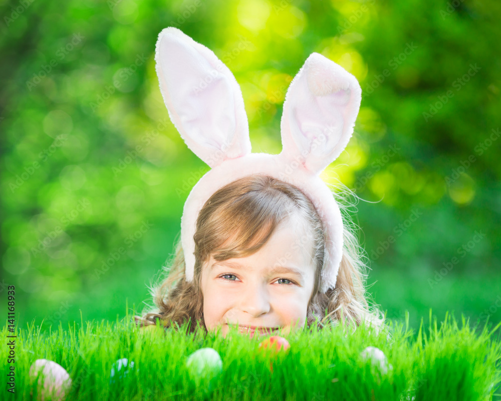 Easter bunny and eggs on green grass