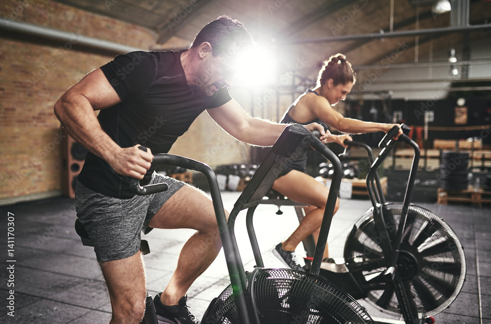 Man and woman riding fast on simulators