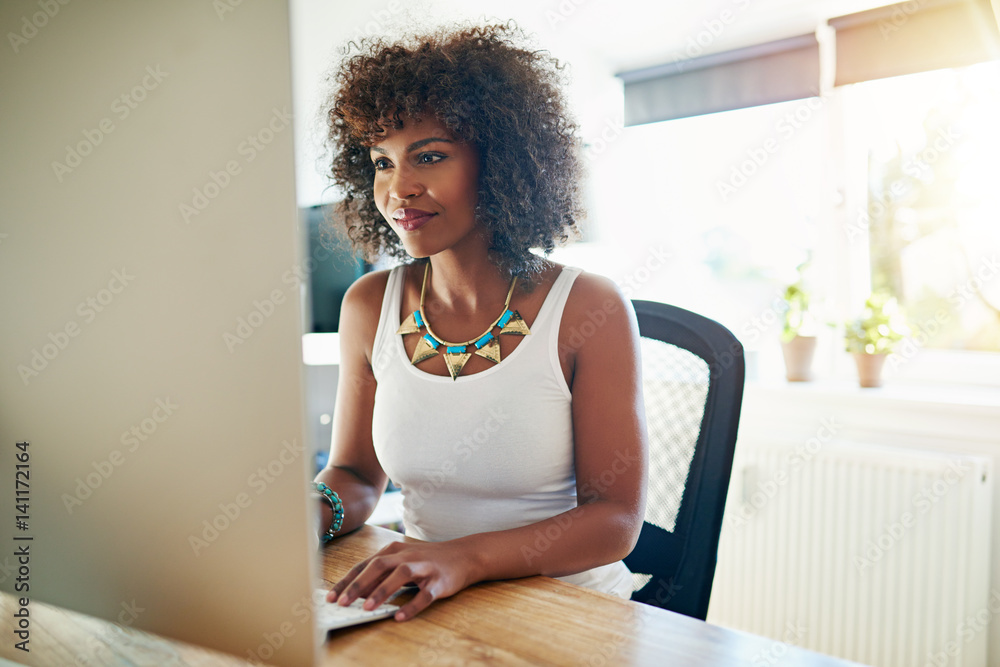 Young African American woman working at a computer