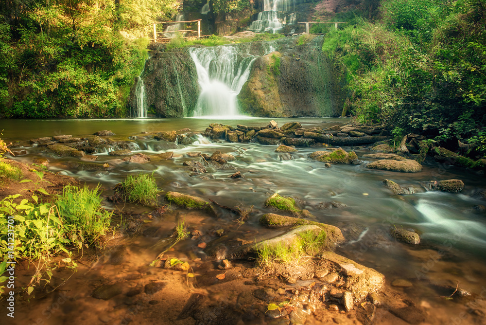 Beautiful mountain rainforest waterfall with fast flowing water and rocks, long exposure. Natural se