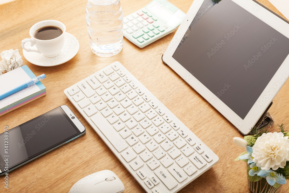 smartphone with pencil,coffee cup,calendar,calculator,bottle water,computer pc,tablet and flower on 