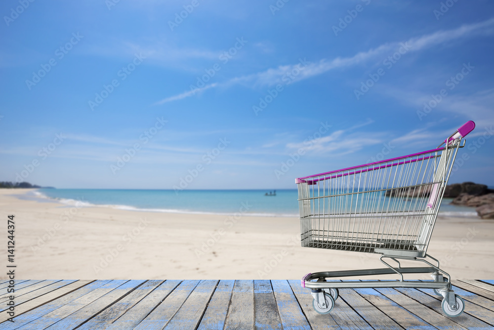 miniature shopping cart on tropical beach, for summer  shopping and summer sale background concept.