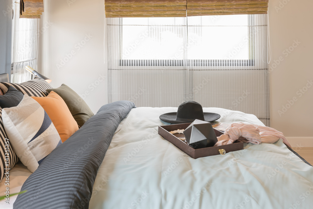 set of pillows on bed with blanket in blue bedroom