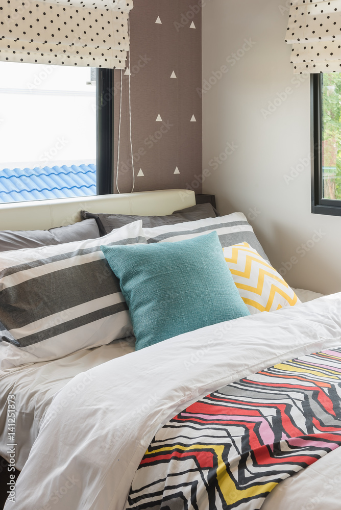 colorful pillows set on bed in modern bedroom style