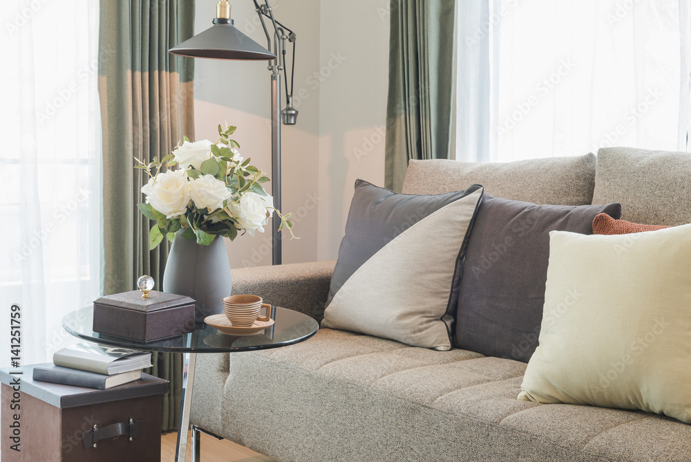 vase of flower on round glass table with set of sofa in modern living room