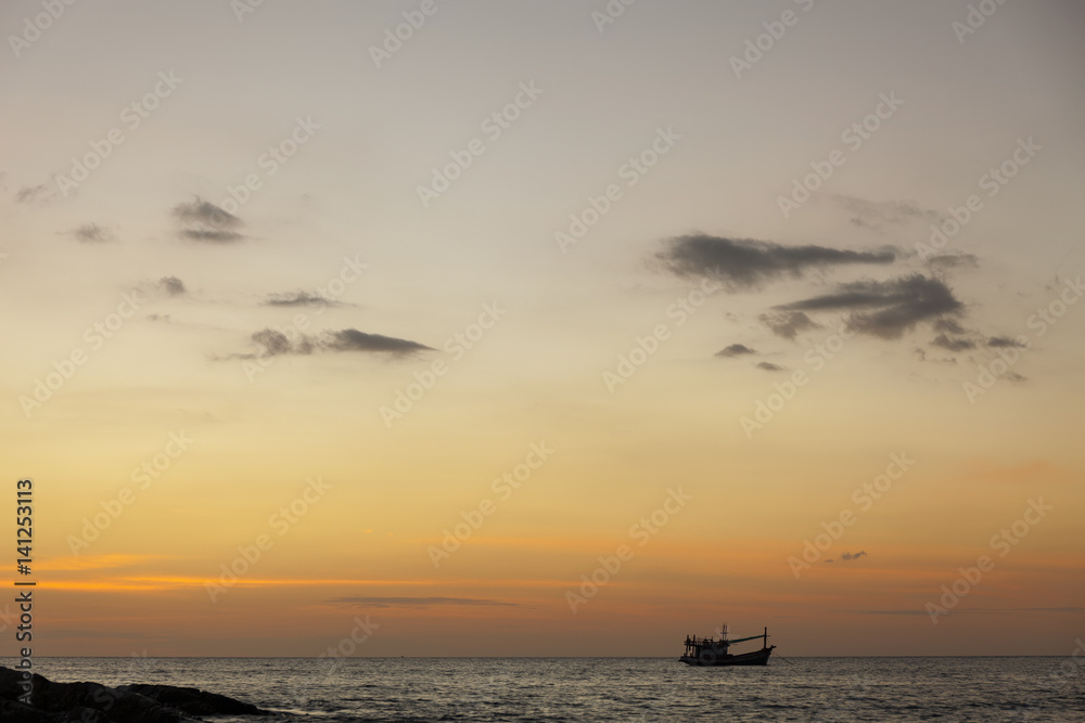 安达曼海中岩石和船只的戏剧性海景。泰国普吉岛色彩缤纷的日落。