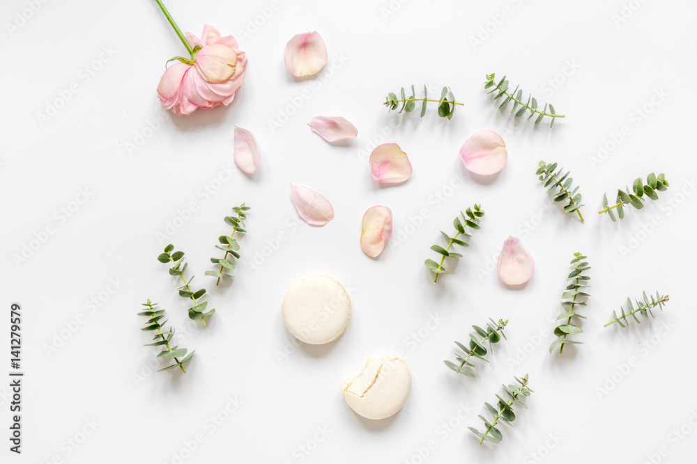 woman table design with flower and macaroons in soft light top view