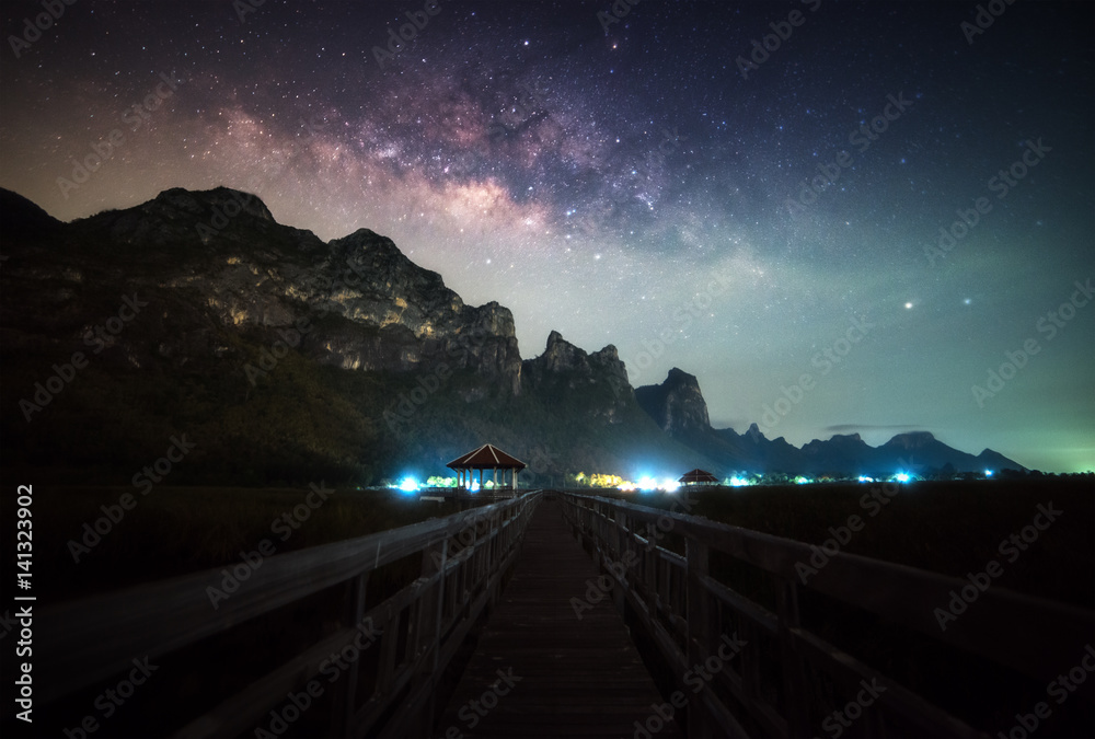 Clearly Milky way with wooden path beautiful scene in Thailand.