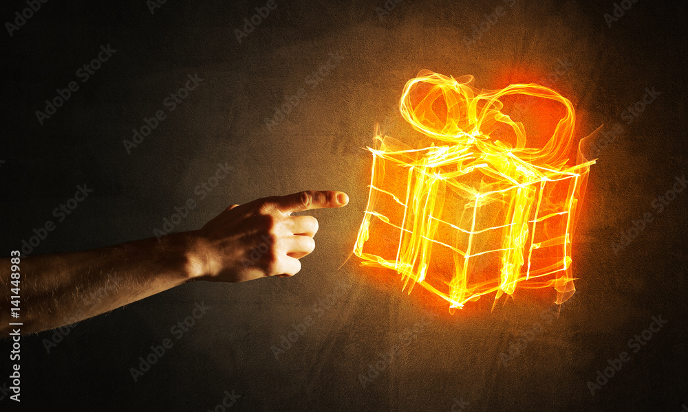 Concept of celebration with fire burning gift symbol and creation gesture