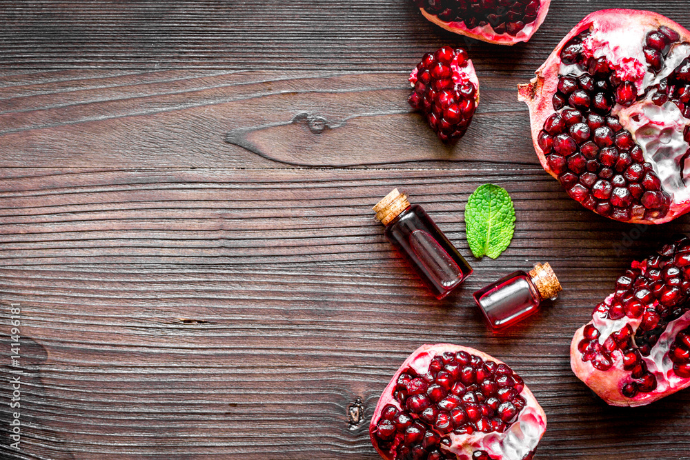 sliced pomegranate on wooden background top view