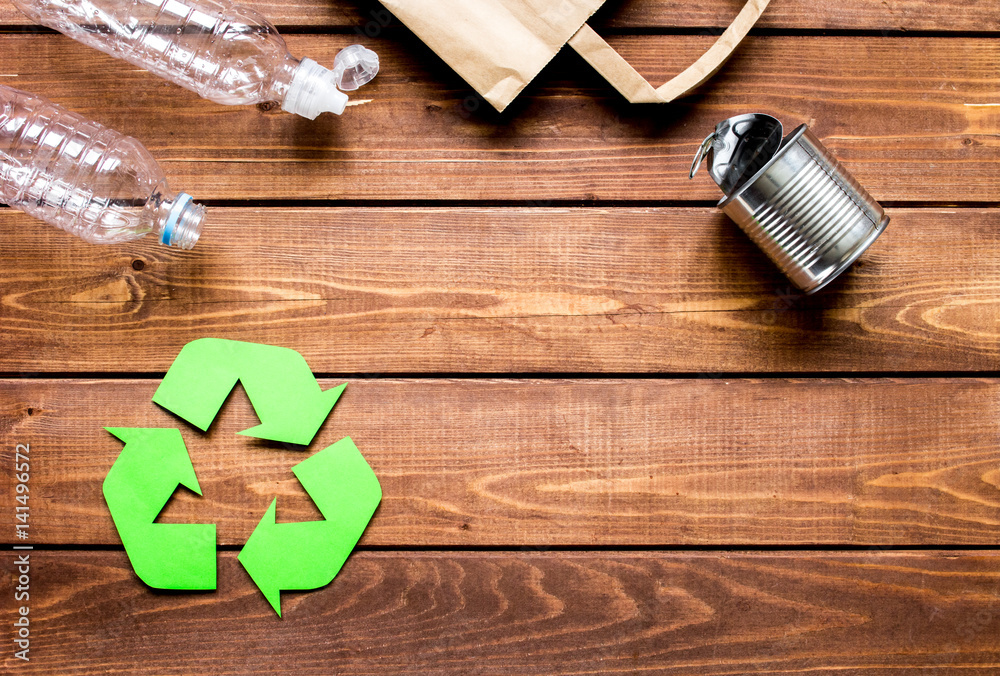 environment concept with recycling symbol on wooden background top view mock up