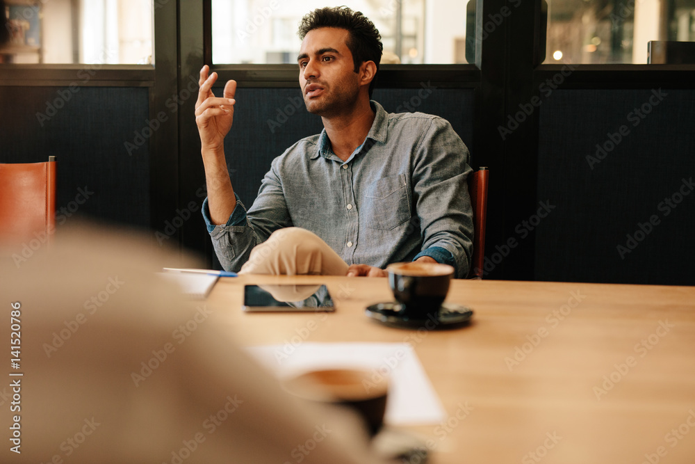 Businessman talking with coworkers in office